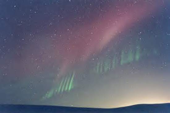 Filaments of the aurora in 2002 July 2. The filaments and their equal distances from each other show the electric origin similar to red sprites. No branches are there. Credit: Anderson SpaceWeather
